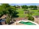 Lovely view of a sprawling park beyond the walled-in backyard with an in-ground pool at 16554 W Saguaro Ln, Surprise, AZ 85388