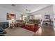 Spacious living room with a ceiling fan, plush seating, modern decor, and laminate flooring at 16554 W Saguaro Ln, Surprise, AZ 85388