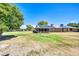 Spacious backyard with lush lawn and solar panels on the roof at 16842 N 103Rd Dr, Sun City, AZ 85351