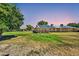 Spacious backyard with lush lawn and solar panels on the roof at 16842 N 103Rd Dr, Sun City, AZ 85351