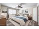 This bedroom features soft carpeting, updated ceiling fan and modern curtains for a cozy feel at 16842 N 103Rd Dr, Sun City, AZ 85351