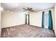 This bedroom offers generous space, natural light from the window, and a ceiling fan for added comfort at 16842 N 103Rd Dr, Sun City, AZ 85351