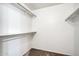 A simple walk-in closet features shelving and hanging rods for organized storage and functionality at 16842 N 103Rd Dr, Sun City, AZ 85351
