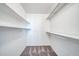 This walk-in closet is designed with rods and shelving for efficient storage and easy organization at 16842 N 103Rd Dr, Sun City, AZ 85351