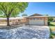 Well-maintained front exterior with a two-car garage and landscaping at 16842 N 103Rd Dr, Sun City, AZ 85351