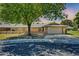 Charming front exterior with two-car garage and mature trees at 16842 N 103Rd Dr, Sun City, AZ 85351