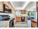 Well-lit kitchen featuring wooden cabinets, modern appliances, and a convenient layout at 16842 N 103Rd Dr, Sun City, AZ 85351