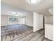 Open-concept living area featuring a large window, sliding glass door, and modern flooring at 16842 N 103Rd Dr, Sun City, AZ 85351