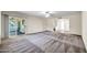 Spacious living area with sliding glass doors leading to a screened patio at 16842 N 103Rd Dr, Sun City, AZ 85351