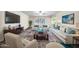 Bright living room with neutral decor, including stylish furniture and large windows at 16842 N 103Rd Dr, Sun City, AZ 85351