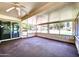 Relaxing sunroom with large windows, ceiling fan, and exterior views at 16842 N 103Rd Dr, Sun City, AZ 85351