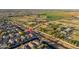 A high-angle shot shows a residential street bordering community fields with a backdrop of lush greenery at 17416 W Ventura St, Surprise, AZ 85388