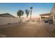 Spacious backyard featuring a covered patio, barbecue grill, fire pit, seating area, and a block wall for privacy at 17416 W Ventura St, Surprise, AZ 85388
