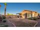 Wide angle view of backyard featuring a covered patio, barbecue grill, fire pit, seating area, and desert landscaping at 17416 W Ventura St, Surprise, AZ 85388