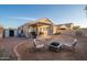 View of backyard featuring a covered patio with a BBQ grill, a shed, and a seating area around a fire pit at 17416 W Ventura St, Surprise, AZ 85388