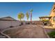 Spacious backyard featuring a covered patio, barbecue grill, fire pit, seating area, and a block wall for privacy at 17416 W Ventura St, Surprise, AZ 85388