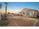 Wide angle view of backyard featuring a covered patio, barbecue grill, fire pit, seating area, and desert landscaping at 17416 W Ventura St, Surprise, AZ 85388