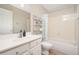 Bright bathroom features a vanity with storage, modern fixtures, and a shower/tub combo with a blue and white striped curtain at 17416 W Ventura St, Surprise, AZ 85388