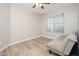 Spare bedroom features modern ceiling fan, wood floors, and window views at 17416 W Ventura St, Surprise, AZ 85388