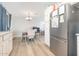 Bright dining area with a modern chandelier, wood floors, and neutral paint at 17416 W Ventura St, Surprise, AZ 85388