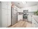 Bright kitchen featuring white cabinetry, stainless steel appliances, and modern fixtures at 17416 W Ventura St, Surprise, AZ 85388