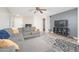 Cozy living room featuring a gray sectional sofa, modern rug, and a wall-mounted TV at 17416 W Ventura St, Surprise, AZ 85388