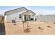 New backyard with covered patio, young trees, and plenty of room for customization at 17830 W Mission Ln, Waddell, AZ 85355