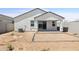 View of back of house and covered patio with dirt yard at 17830 W Mission Ln, Waddell, AZ 85355