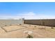 Dirt backyard featuring block wall with newly planted young trees at 17830 W Mission Ln, Waddell, AZ 85355