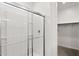 Modern bathroom features glass enclosed shower with sleek chrome hardware and neutral tile at 17830 W Mission Ln, Waddell, AZ 85355