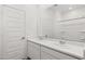 Bright bathroom featuring a double sink vanity and a large mirror at 17830 W Mission Ln, Waddell, AZ 85355