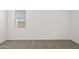 A neutral bedroom with neutral carpet, white walls, white trim, and one window at 17830 W Mission Ln, Waddell, AZ 85355