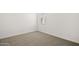 Neutral bedroom with neutral carpet, white walls, white trim, and one window at 17830 W Mission Ln, Waddell, AZ 85355