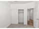 Clean, carpeted bedroom with closet and view to an adjacent room at 17830 W Mission Ln, Waddell, AZ 85355