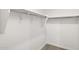Walk-in closet features carpet and ample shelving with rods for clothing storage at 17830 W Mission Ln, Waddell, AZ 85355