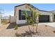 Home with a two-car garage, desert landscaping, and block wall fencing at 17830 W Mission Ln, Waddell, AZ 85355