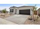 Single-story home with desert landscaping, a two-car garage, and a concrete driveway at 17830 W Mission Ln, Waddell, AZ 85355