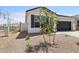 Single-story home with desert landscaping, a two-car garage, and block wall fencing at 17830 W Mission Ln, Waddell, AZ 85355