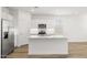 Open concept kitchen with stainless steel appliances and a large island at 17830 W Mission Ln, Waddell, AZ 85355