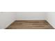 Neutral room showcasing wood-style flooring and white walls, offering a blank canvas for customization at 17830 W Mission Ln, Waddell, AZ 85355