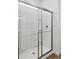 Modern glass enclosed shower with chrome hardware and built in shelving at 17830 W Mission Ln, Waddell, AZ 85355