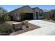 Stylish single-story house featuring a two-car garage and low maintenance desert landscaping at 18765 W Adams St, Buckeye, AZ 85326