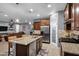 Open concept kitchen with granite island, pantry and stainless steel appliances flows into living area at 20194 N Riverbank Rd, Maricopa, AZ 85138