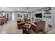 A spacious living room with large windows, neutral walls, tile floor and comfortable leather seating at 20194 N Riverbank Rd, Maricopa, AZ 85138