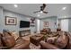 Large living room offering comfortable leather seating and a media center, creating an inviting gathering space at 20194 N Riverbank Rd, Maricopa, AZ 85138