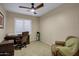 Bright office space with a dark wood desk, comfortable chair, and plantation shutters at 20194 N Riverbank Rd, Maricopa, AZ 85138