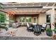 Outdoor patio area with stylish furniture, a dining table, and a barbecue grill at 20194 N Riverbank Rd, Maricopa, AZ 85138