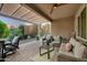 Covered patio with comfortable seating, offering a relaxing outdoor space at 20194 N Riverbank Rd, Maricopa, AZ 85138