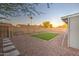 The backyard includes an irrigated and curbed grass area with pavers at 2122 E Radcliffe Dr, Tempe, AZ 85283