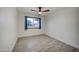 This bright bedroom features a ceiling fan and wood look flooring at 2122 E Radcliffe Dr, Tempe, AZ 85283